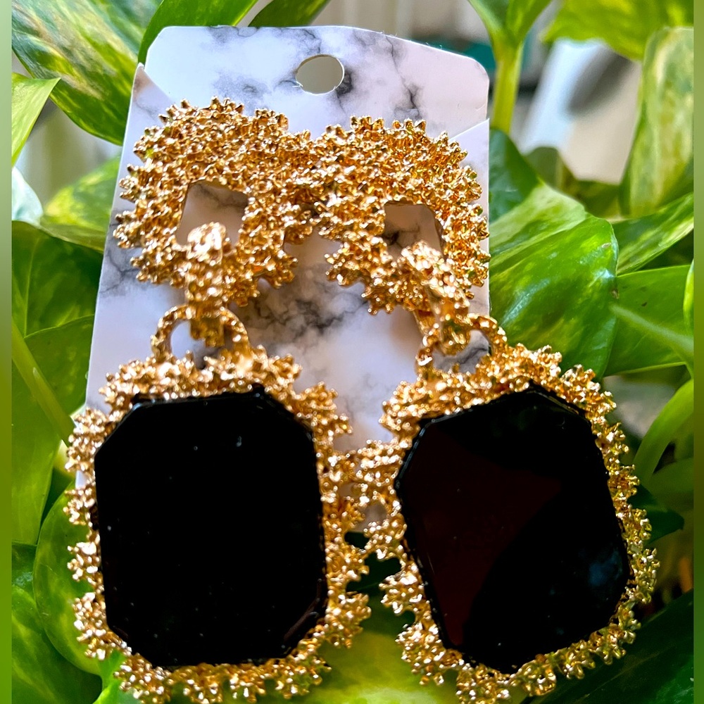 Gold-tone and black earrings.